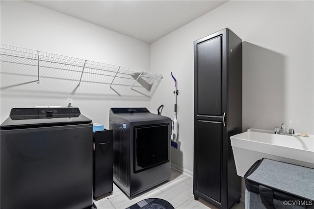 laundry room with washing machine and dryer and sink