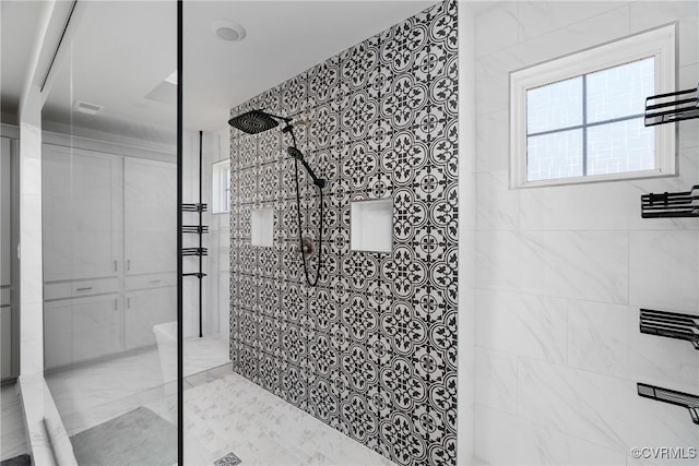 bathroom with tiled shower