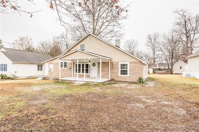 view of front of property with a front yard and a patio area