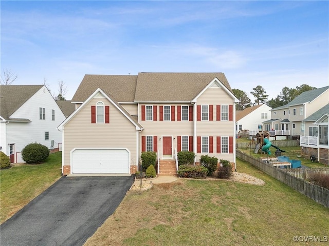 view of front of home with a front yard and a garage