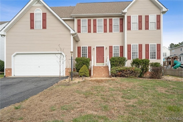 view of front facade featuring a front lawn and a garage