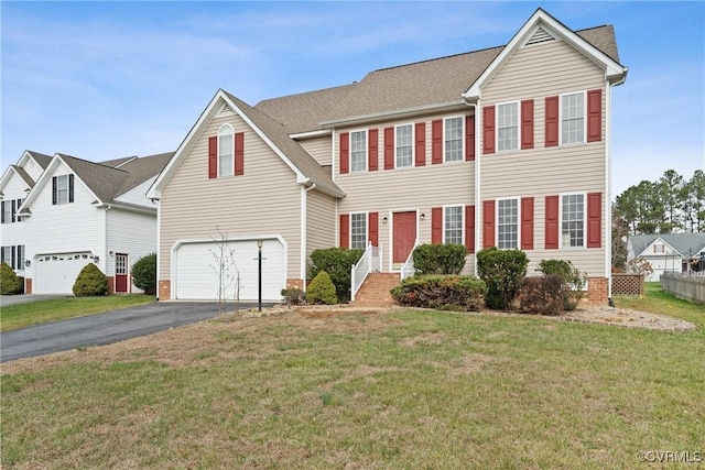 view of front facade featuring a front yard and a garage