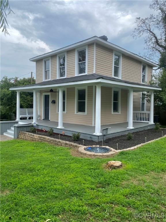 farmhouse-style home with a porch and a front yard