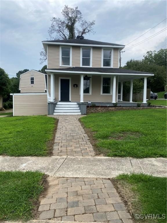 view of front facade with a front lawn and covered porch