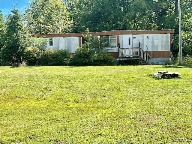 view of front facade with a front yard and a deck