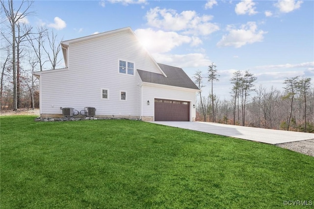 view of home's exterior with a garage, central air condition unit, and a yard