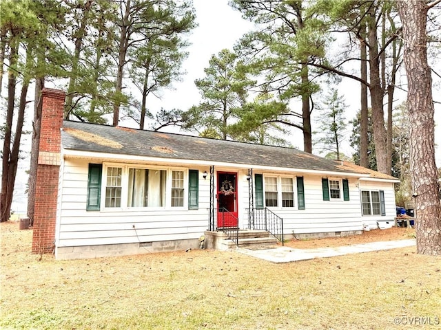 ranch-style home with a front lawn