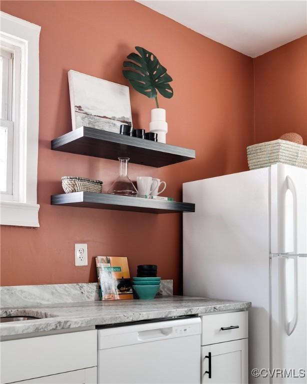 kitchen with white appliances and white cabinetry