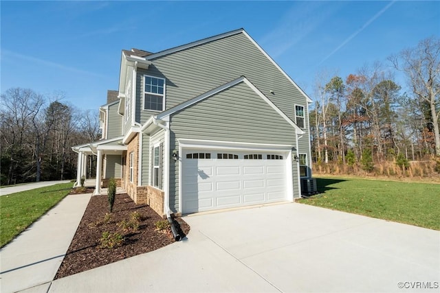 view of side of property with a lawn and a garage