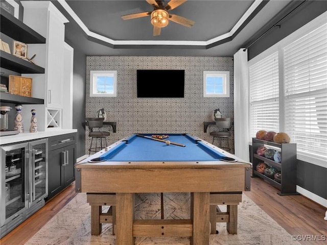 playroom featuring a raised ceiling, light hardwood / wood-style flooring, beverage cooler, and pool table