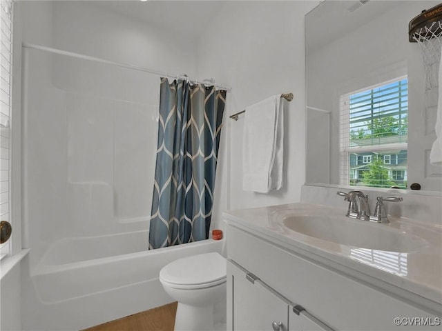 full bathroom featuring vanity, toilet, wood-type flooring, and shower / tub combo