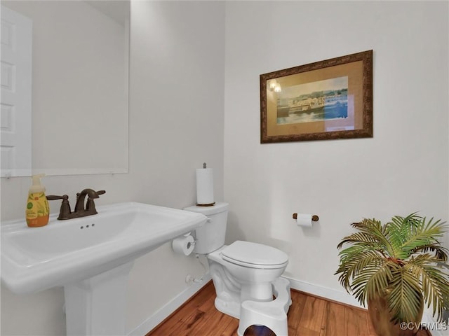 bathroom featuring hardwood / wood-style floors, toilet, and sink