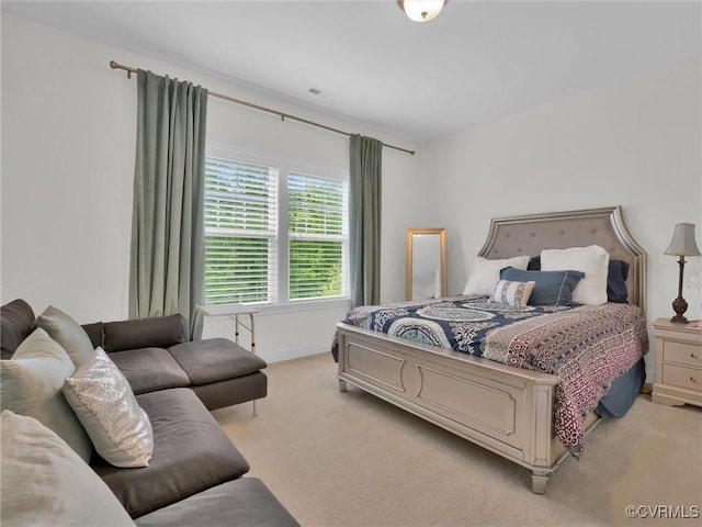 bedroom featuring light carpet