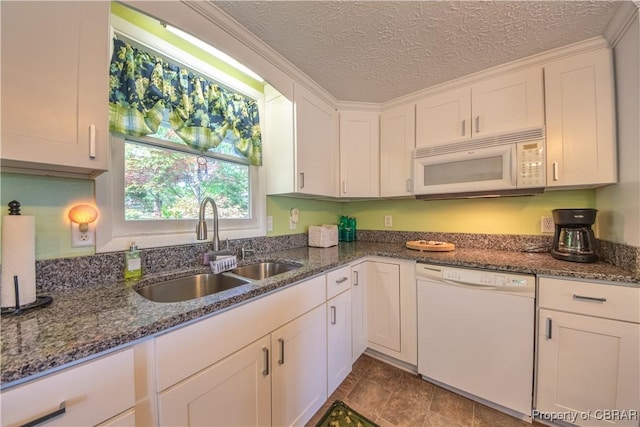 kitchen with white appliances, dark stone counters, sink, a textured ceiling, and white cabinetry