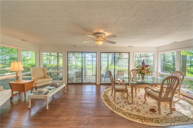 sunroom / solarium featuring ceiling fan and a healthy amount of sunlight