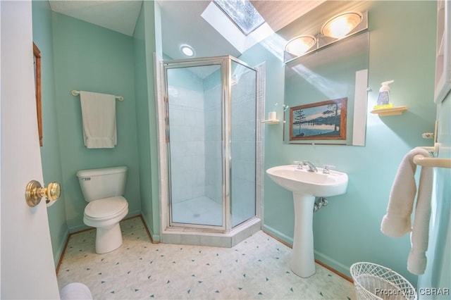 bathroom with a skylight, toilet, and walk in shower