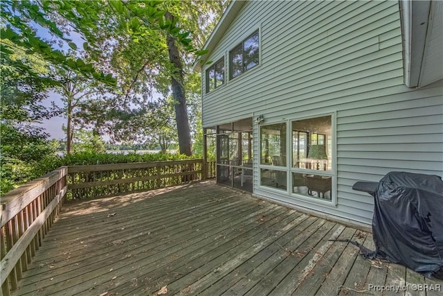 wooden terrace with grilling area and a sunroom