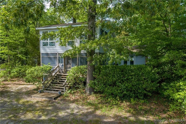 back of house featuring a sunroom