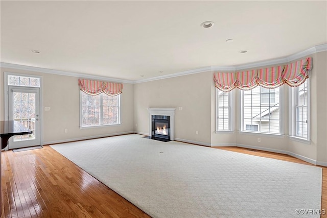 unfurnished living room featuring crown molding and light hardwood / wood-style flooring