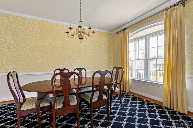 dining room with a chandelier, baseboards, and wallpapered walls