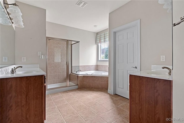 full bathroom featuring a bath, a stall shower, visible vents, and a sink