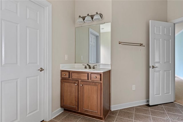 bathroom featuring vanity, baseboards, and tile patterned floors