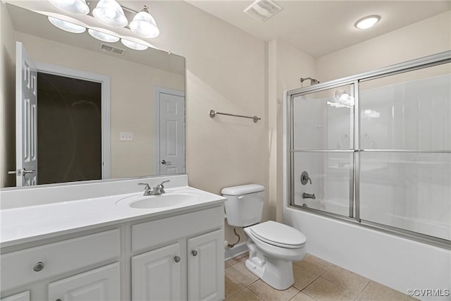 full bathroom with toilet, vanity, tile patterned floors, and enclosed tub / shower combo