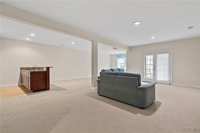 living area with french doors, recessed lighting, visible vents, light carpet, and baseboards