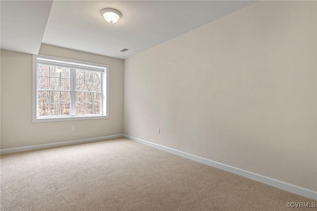 unfurnished room featuring light colored carpet