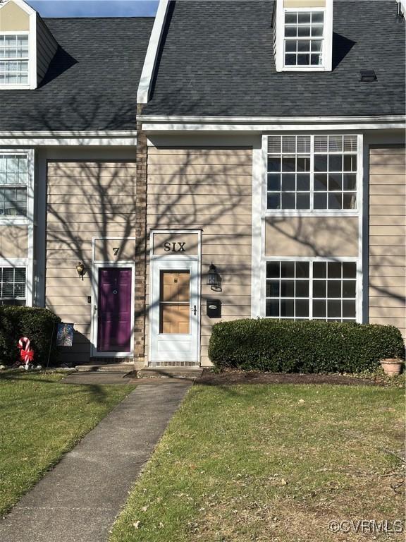 view of exterior entry with a yard