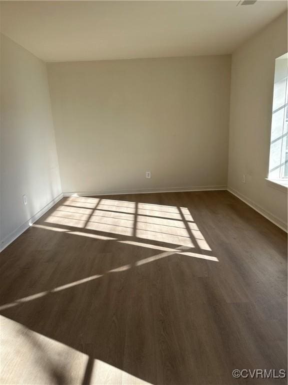 empty room featuring dark wood-type flooring