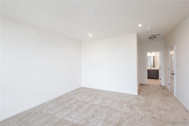 unfurnished room with light colored carpet