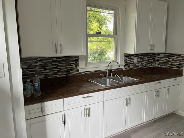 kitchen featuring white cabinetry, a healthy amount of sunlight, and sink