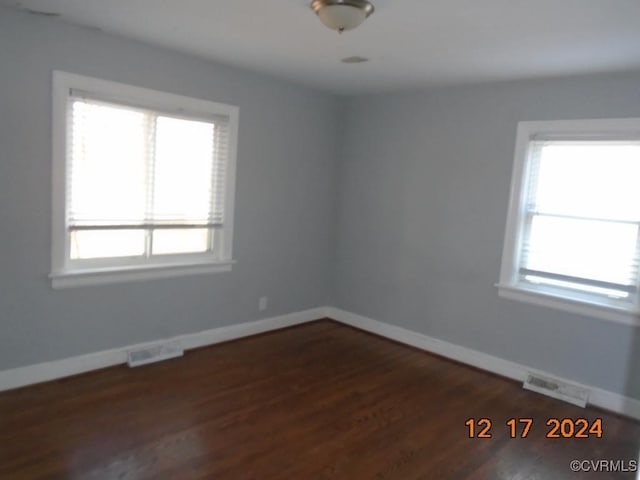 empty room with dark wood-type flooring