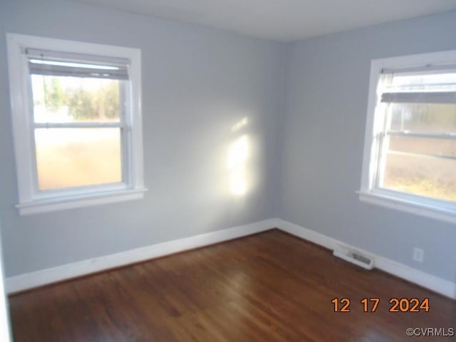 spare room with dark hardwood / wood-style flooring