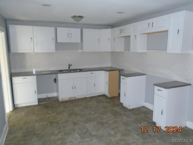 kitchen featuring sink and white cabinets