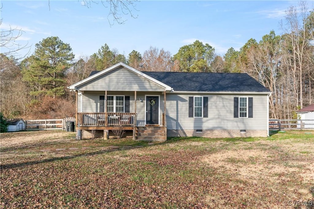 ranch-style home with covered porch and a front lawn