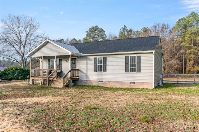 ranch-style home featuring a porch and a front yard