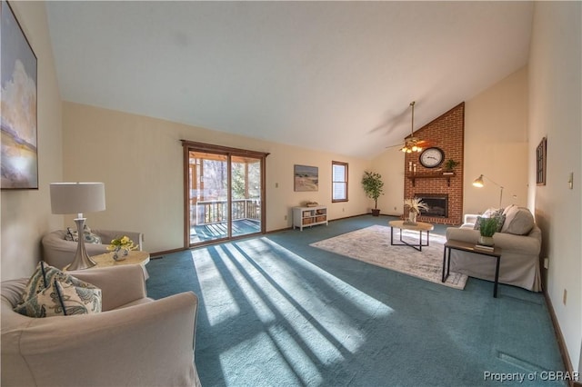 living room featuring carpet floors, ceiling fan, a fireplace, and high vaulted ceiling