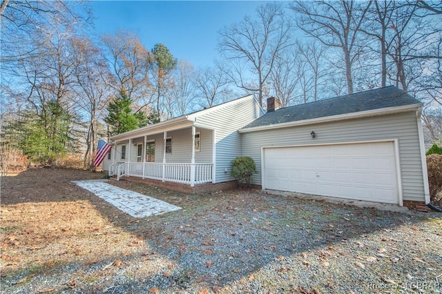 single story home featuring covered porch and a garage