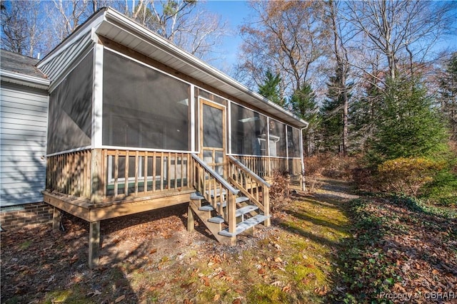 rear view of house featuring a sunroom