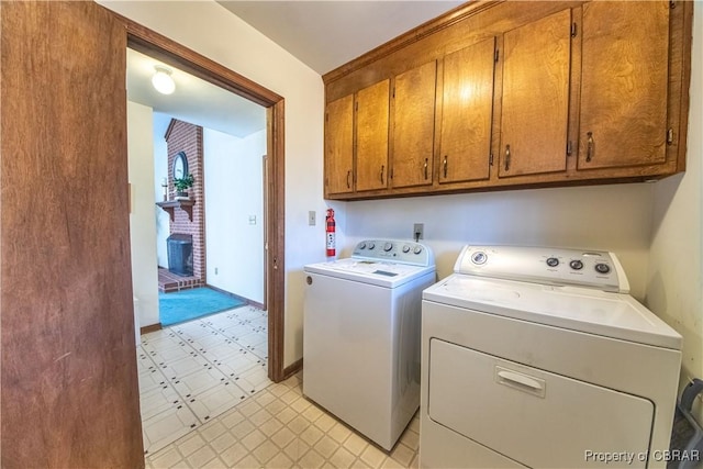 clothes washing area featuring cabinets and independent washer and dryer