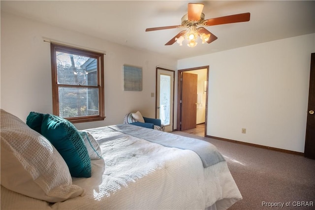 bedroom with light colored carpet, ensuite bath, and ceiling fan