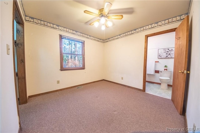 unfurnished bedroom with ensuite bath, ceiling fan, and light colored carpet