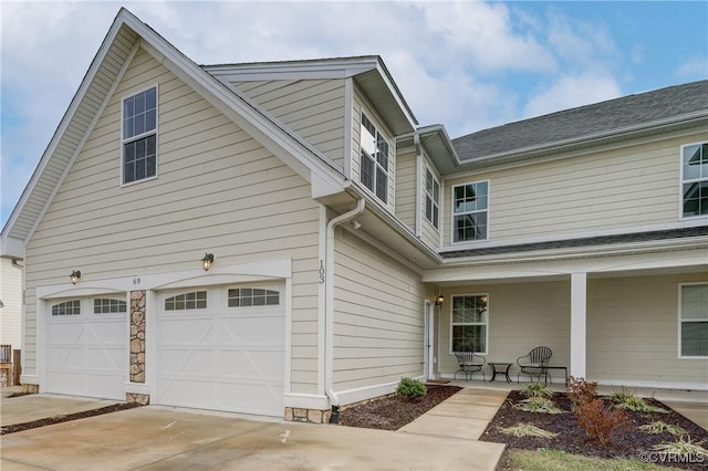 view of front of home featuring a porch and a garage