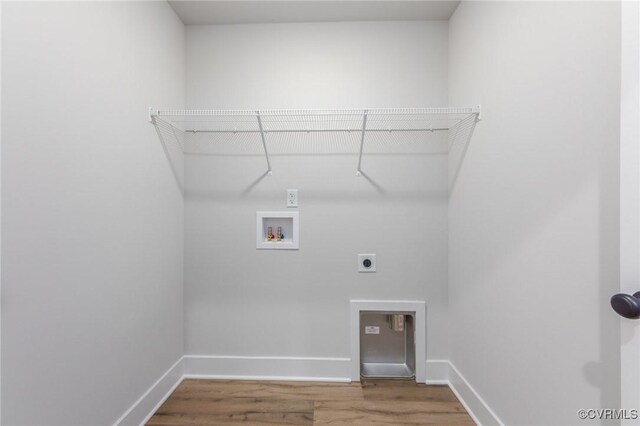 washroom with hookup for an electric dryer, washer hookup, and hardwood / wood-style flooring