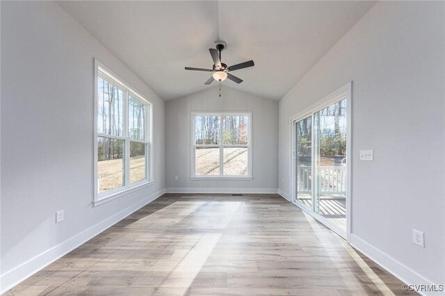 spare room featuring ceiling fan, light wood-type flooring, and vaulted ceiling