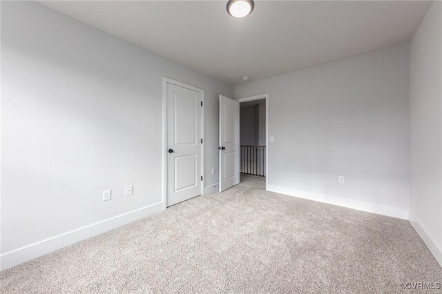 empty room featuring light carpet