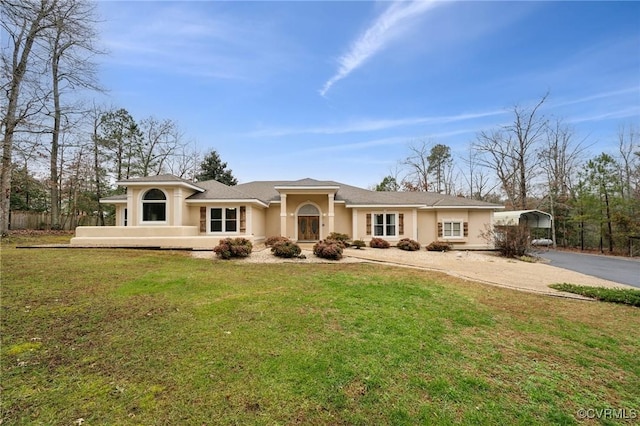 back of property with a yard and a carport