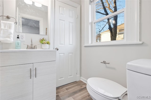 bathroom featuring hardwood / wood-style floors, vanity, and toilet